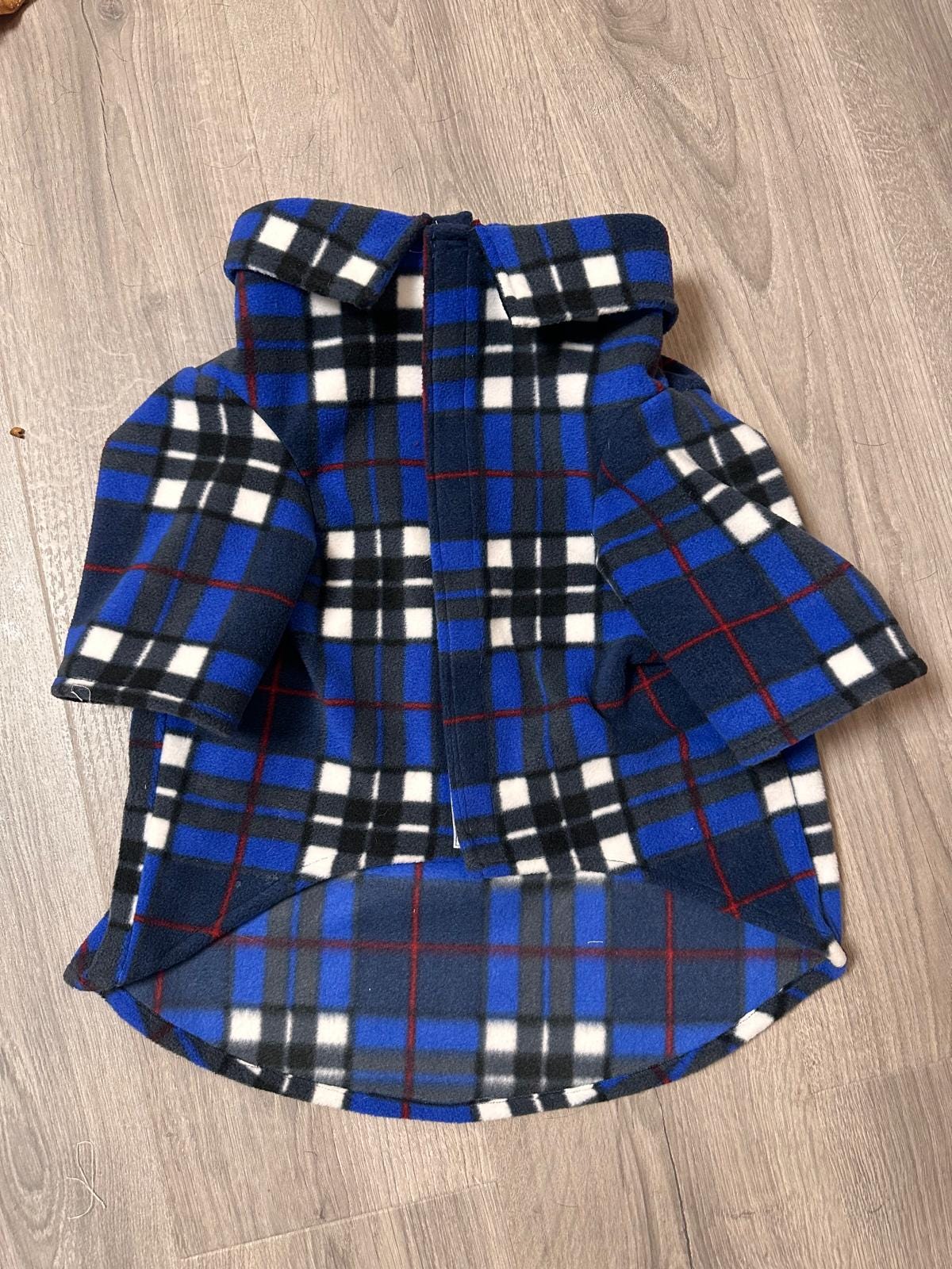 Keep your dog warm stylish in this handmade royal blue plaid fleece jacket! Features a fold-over collar, sleeves easy Velcro front.
